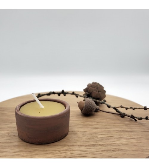 Beeswax candle in a pot