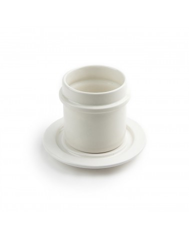 white pottery cup and saucer